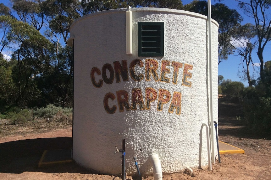 Water tank done up to be a toilet with Concrete Crappa written on it