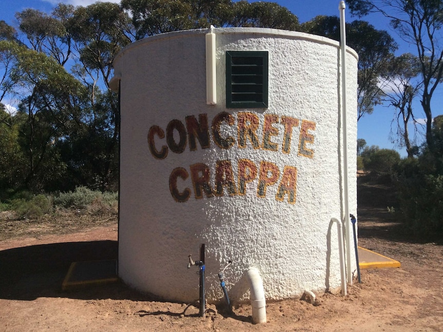 Water tank done up to be a toilet with Concrete Crappa written on it