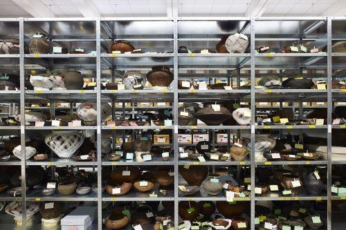 Metal shelving with a diversity of ancient puts on them