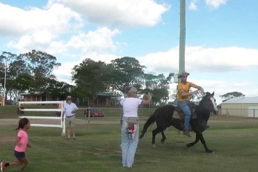 A still from a video of a man riding a horse into the arena at Clermont.