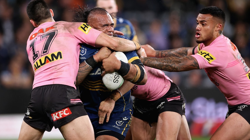 A man is tackled during an NRL match