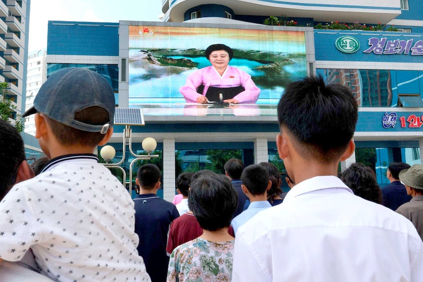 North Koreans watch a televised news report announcing the nation's sixth nuclear test since 2006.