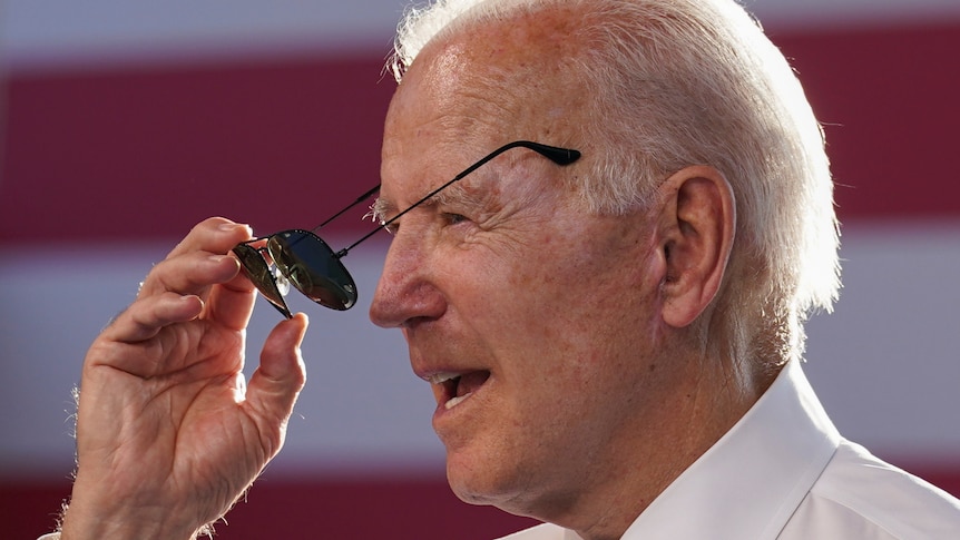 U.S. President Joe Biden puts on sunglasses