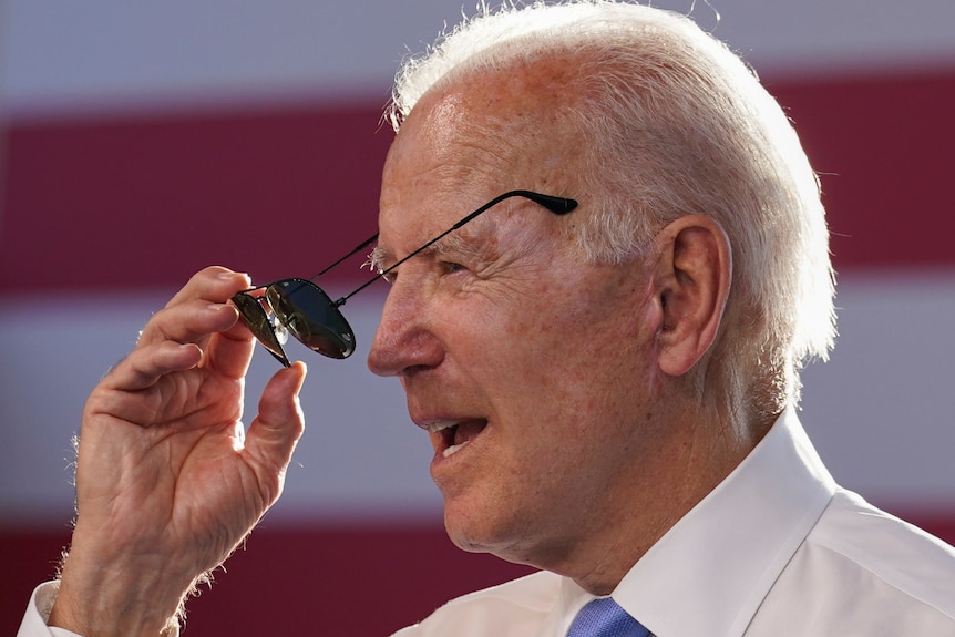 U.S. President Joe Biden puts on sunglasses