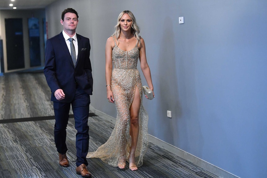 Lachie and Julie Neale walk into the Brownlow Medal ceremony at the Gabba.