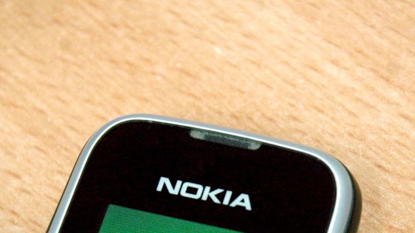 A Nokia mobile phone sits on a desk