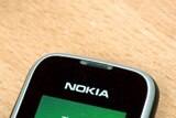 A Nokia mobile phone sits on a desk