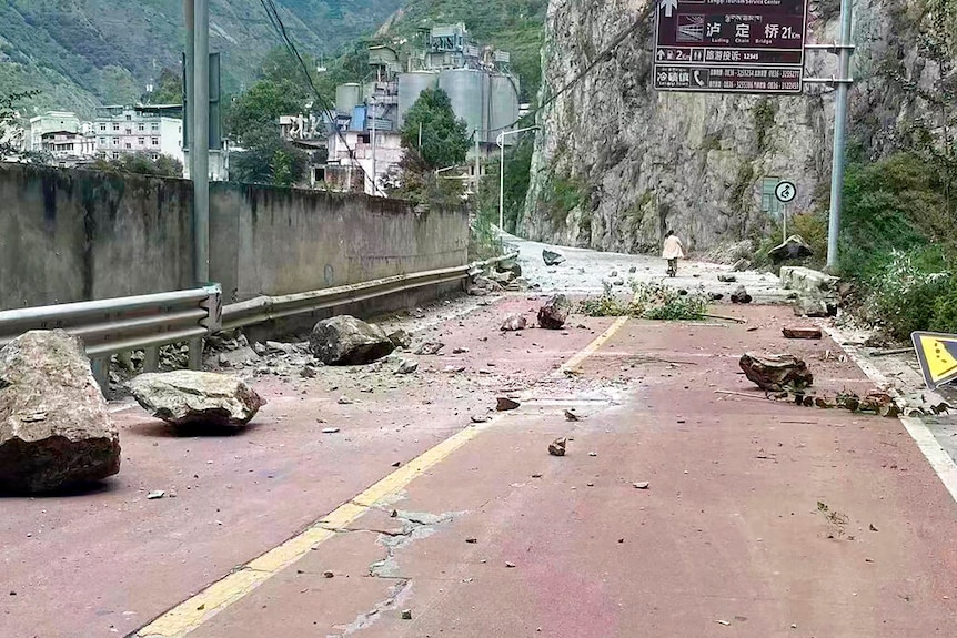 fallen rocks are seen on a road near Lengqi Town in Luding County of southwest China's Sichuan Province.