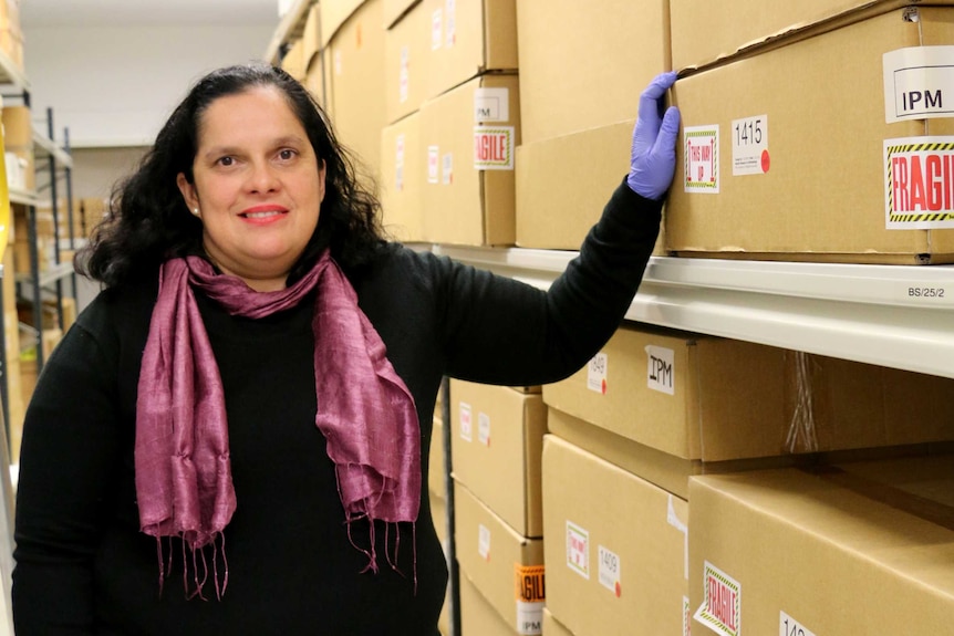 Dr Vanessa Russ stands with storage boxes