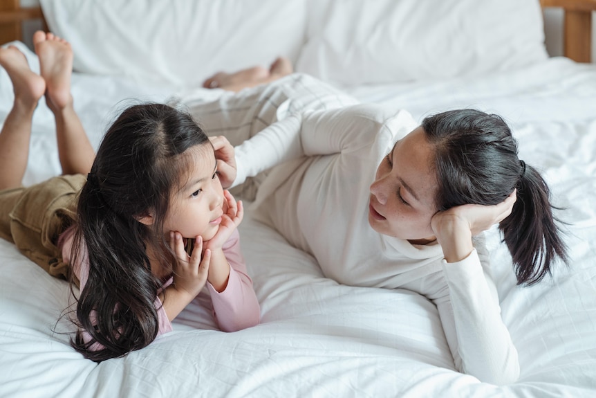 A woman and a child on a bed