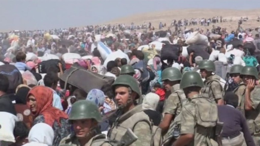Syrian Kurds cross the border into Turkey as Islamic State sweeps over northern Syria.
