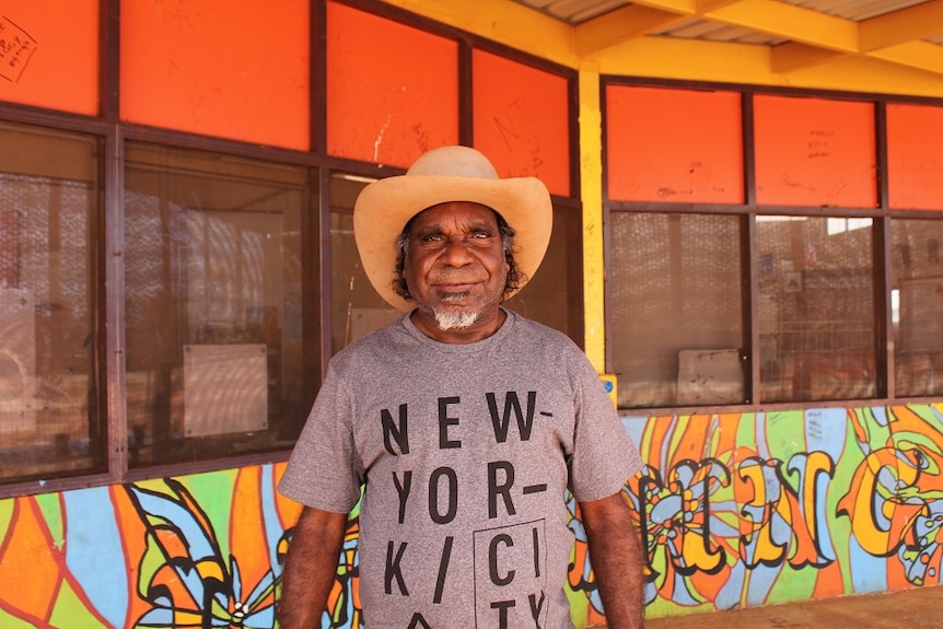 Otto Sims stands outside the centre, wearing an Akubra and a t-shirt that says "New York City".