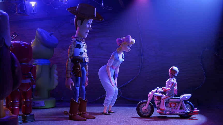 Colour still of toy characters Woody, Bo Peep and Duke Caboom in a nightclub 2019 animated film Toy Story 4.