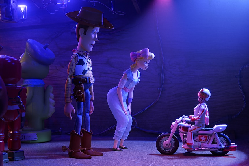Colour still of toy characters Woody, Bo Peep and Duke Caboom in a nightclub 2019 animated film Toy Story 4.
