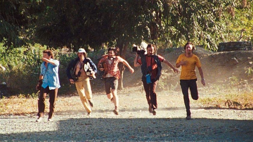 The Balibo Five run from the Indonesian Army in a scene from the movie Balibo