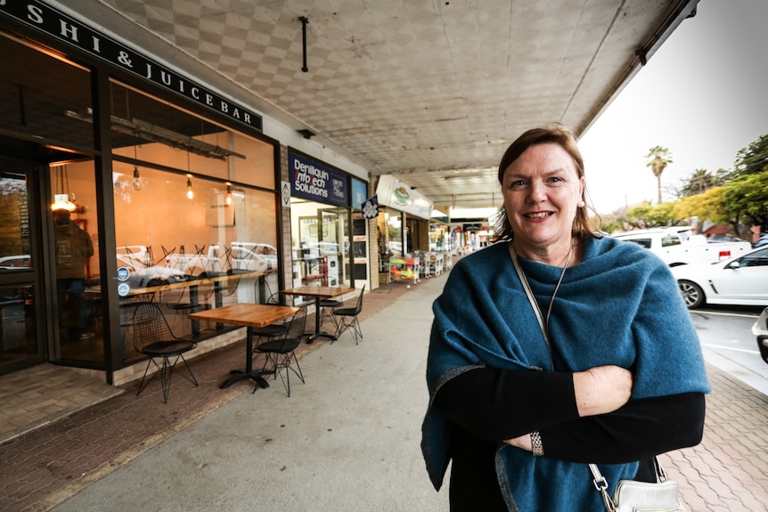 Woman stands in main street of Deniliquin