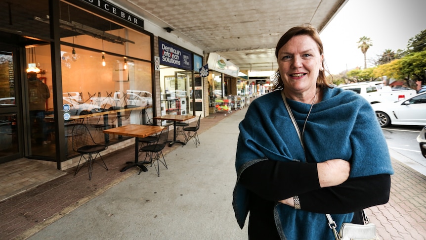 Woman stands in main street of Deniliquin