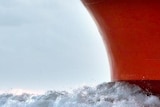 Water passes over the bow of a ship