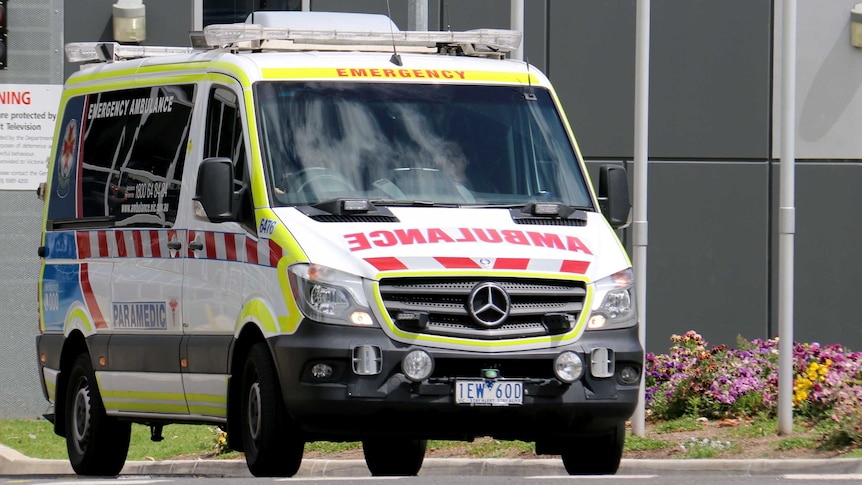 A Victorian ambulance sits outside a justice centre.