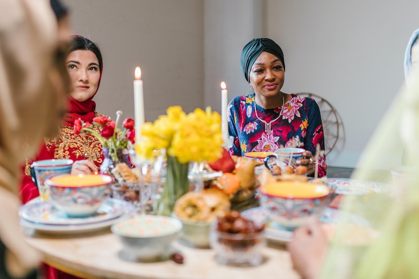 Women gather around a table of food