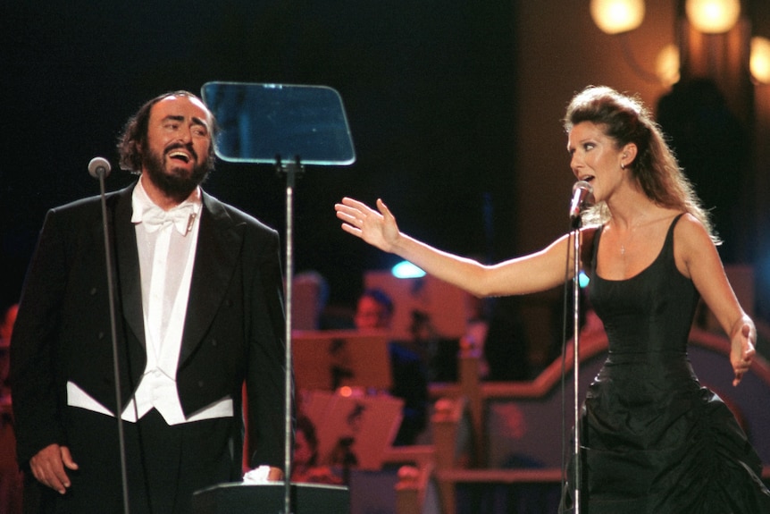Dion performs at a charity gala with Luciano Pavarotti in 1998.