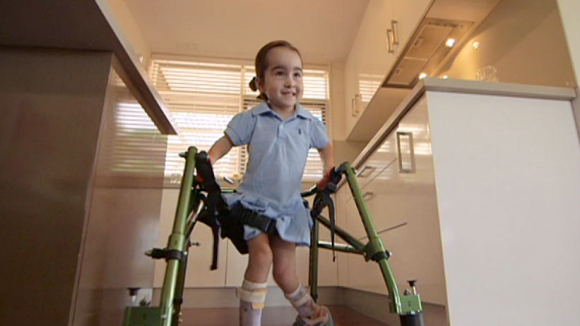 Isabella Lombardo using her walker in the kitchen