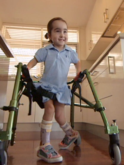 Isabella Lombardo using her walker in the kitchen