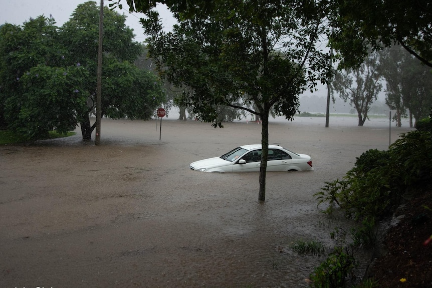 A car surrounded by flood water.