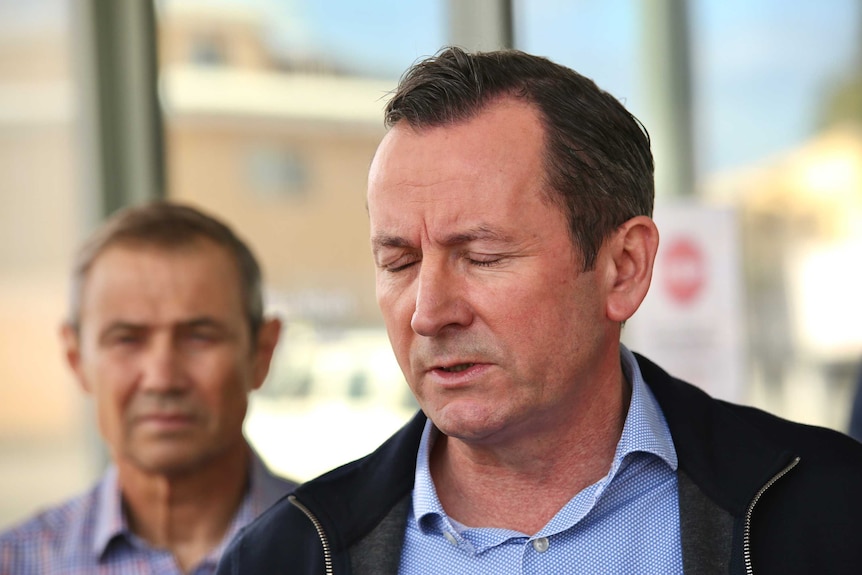 Mark McGowan closes his eyes in frustration at a media conference outside his office in Rockingham.