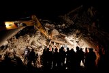 Rescuers work on collapsed house in Italy