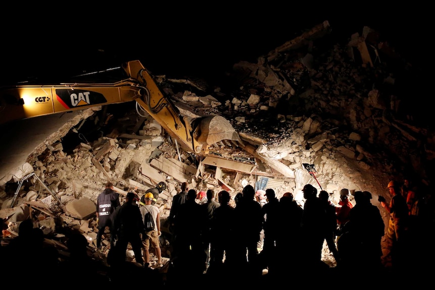 Rescuers work on collapsed house in Italy