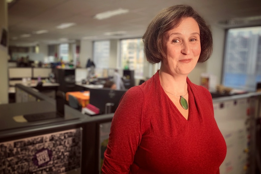 Helen Dalley-Fisher smiles in an office.