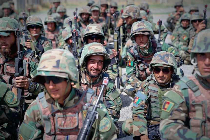 Rows of Afghan soldiers in uniform and helmets.
