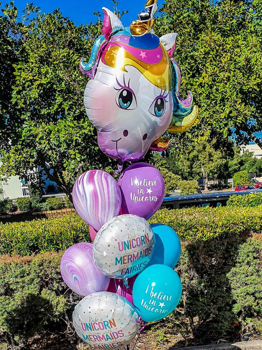 A display of helium balloons featuring a unicorn head
