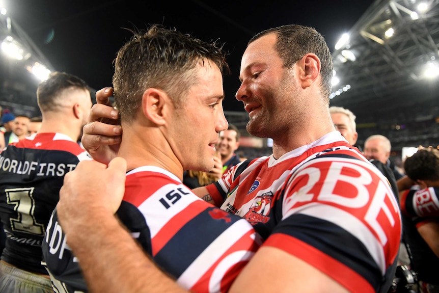 Cooper Cronk and Boyd Cordner hug after winning the NRL grand final.