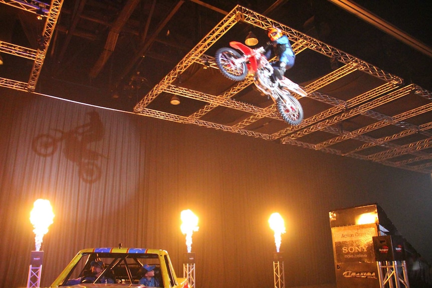 A motocross rider flies through the air