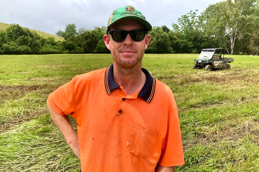 A man in an orange fluoro shirt 