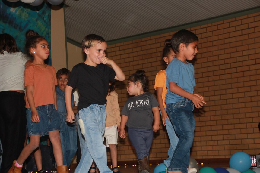 Small children on a catwalk in a fashion parade