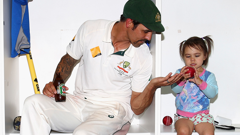 Mitchell Johnson relaxes in the change rooms with his daughter Rubika after his last test match.