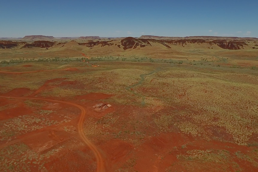 An aerial shot of red dirt and hills