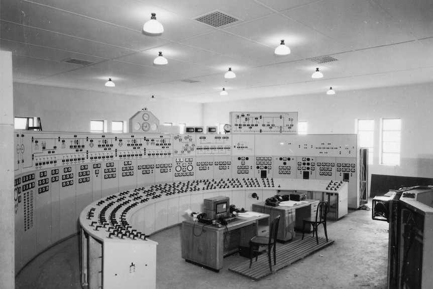 Black and white photograph of a control room inside power station