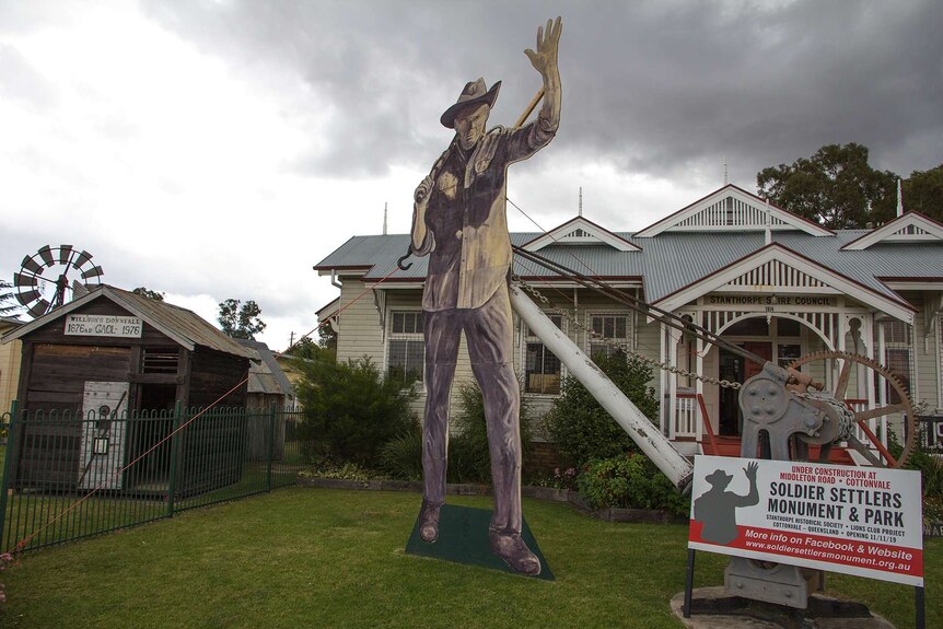 A large wooden image of a soldier settler stands outside the stanthorpe museum