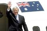 Prime Minister Kevin Rudd waves as he boards his aircraft in Canberra