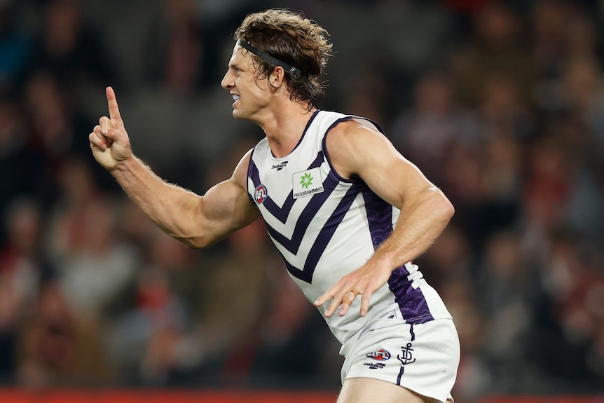 Nat Fyfe holds his finger up in celebration of a goal