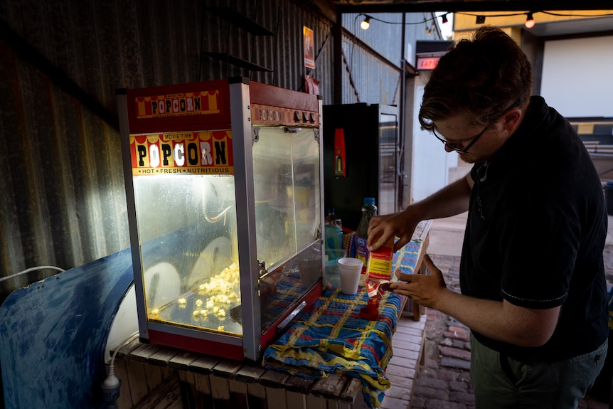 Young man making popcorn