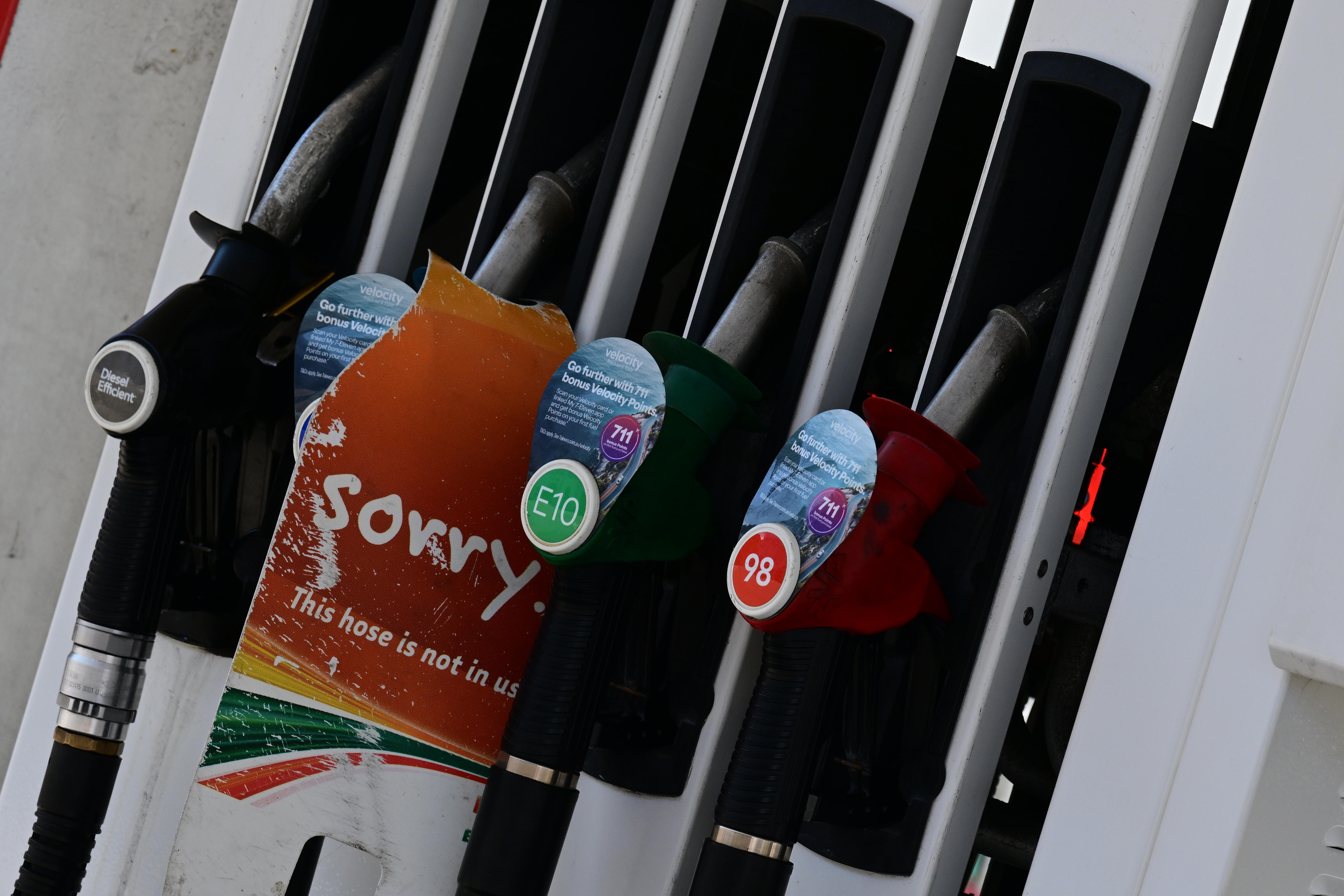 A line of fuel bowsers with a sorry sign. 