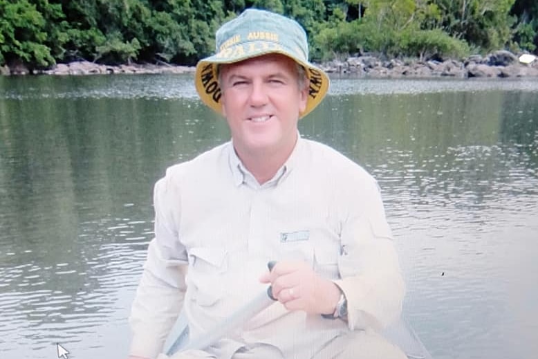 Man in hat near river