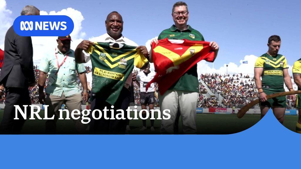 NRL negotiations: PNG Prime Minister and Australian Defence Minister hold NRL jerseys on field.