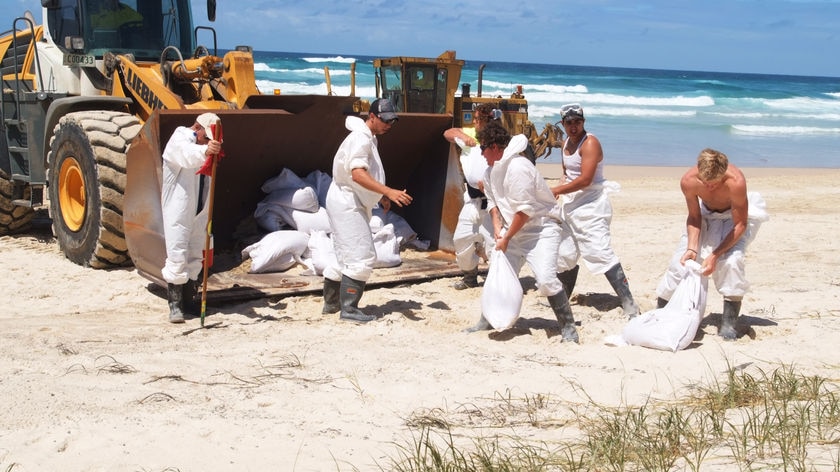 Keep on mopping ... Around 25 per cent of the pollution has been removed from Moreton Island beaches.