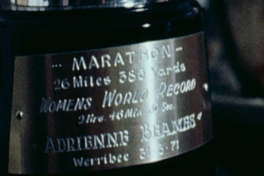 A trophy with an inscription 'women's world record' and Adrienne Beames' name engraved.
